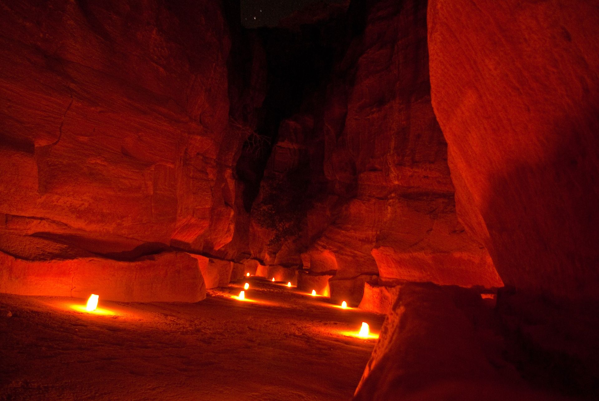 The Siq canyon at night lined with candles